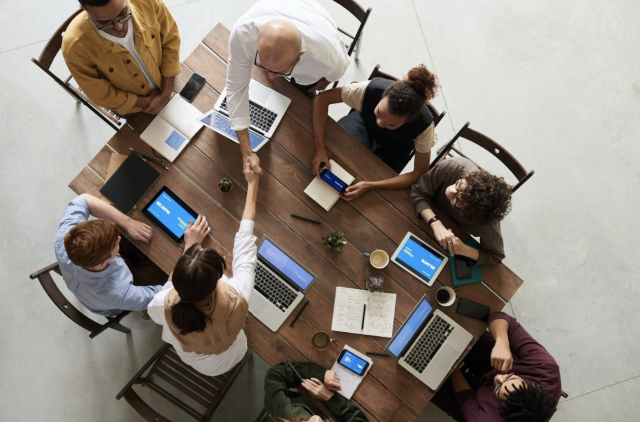Aerial View of Team Members Sitting Around a Conference Table